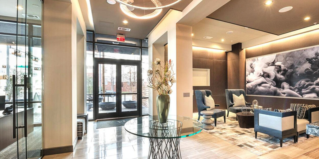 Modern lobby area of Modera building featuring stylish seating, warm lighting, and contemporary decor with a spacious, welcoming ambiance.