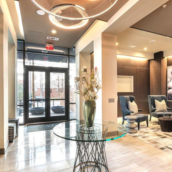 Modern lobby area of Modera building featuring stylish seating, warm lighting, and contemporary decor with a spacious, welcoming ambiance.