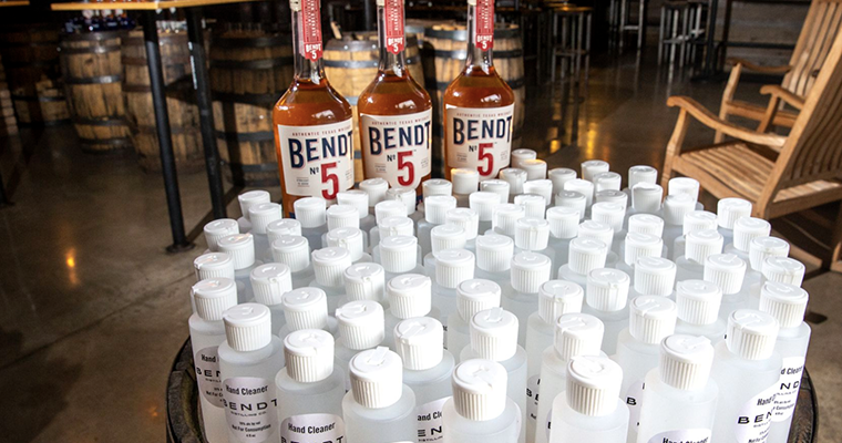 Bendt Distilling Whiskey bottles and empty hand sanitizer bottles to be filled for sanitizing.